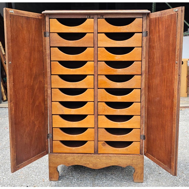 A Mid-Century Mahogany Two-Door French Notaty Cabinet by Misouri Furniture. French doors open to reveal 20 drawers...