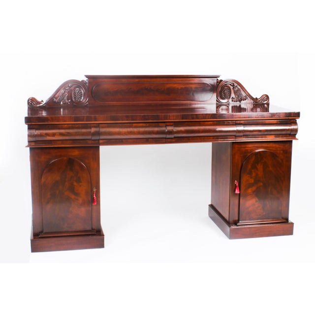 This is a superb antique early Victorian flame mahogany architectural twin pedestal sideboard, circa 1850 in date. The...
