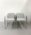 A sleek set of four armchairs by Palecek featuring polished chrome frames with clean, architectural lines. Each chair is...