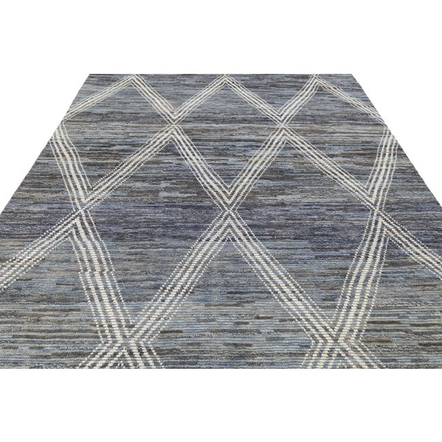This handcrafted wool rug blends traditional Berber weaving with a contemporary style. Its large diamond pattern in slate...