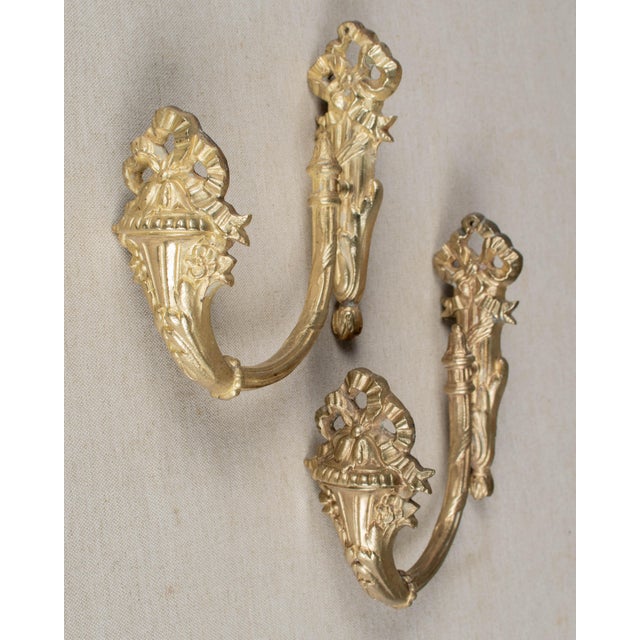 A pair of 19th Century French Louis XVI ctyle cast bronze ormolu curtain tiebacks. Good heavy casting with nice ribbon...