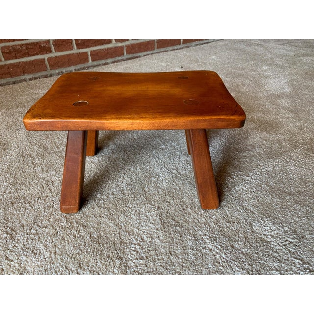 This is a Cushman of Vermont Colonial Creation Cricket Stool No. 9038. It is 14" wide, 9" deep, 8" high. Made of Maple.