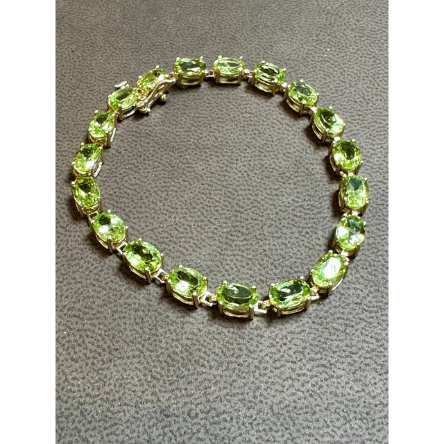 This exceptionally affordable Tennis bracelet has 19 stones of Pear shape Peridot Beautiful colors , very Vibrant Size of...