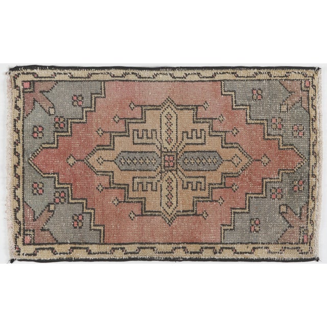 This vintage hand knotted Turkish tribal door mat rug showcases a beautifully timeworn aesthetic with soft, earthy tones....