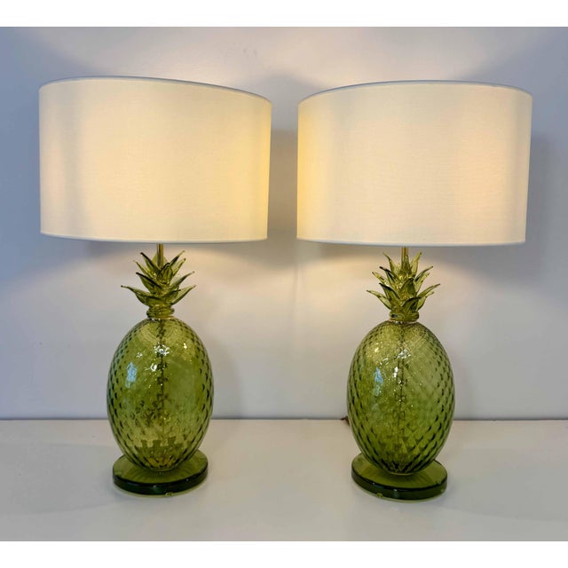 Elegant pair of table lamps crafted in green blown glass, featuring a refined textured surface and a distinctive pineapple...