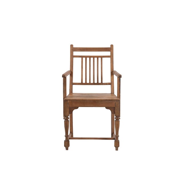 This Vintage Anglo-Indian Teakwood Armchair is handcrafted from solid teakwood, featuring a comfortably angled slatted...