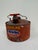 Galvanized metal gasoline can with distressed red painted finish, applied graphics, and wood handle. Styled after early...