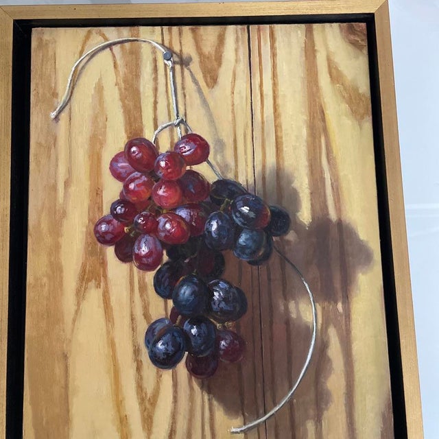 Nice realistic oil painting by Baltimore artist, Andrew Schuler Guerin. Depicts two types of grapes hanging on a cord in...