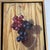 Nice realistic oil painting by Baltimore artist, Andrew Schuler Guerin. Depicts two types of grapes hanging on a cord in...