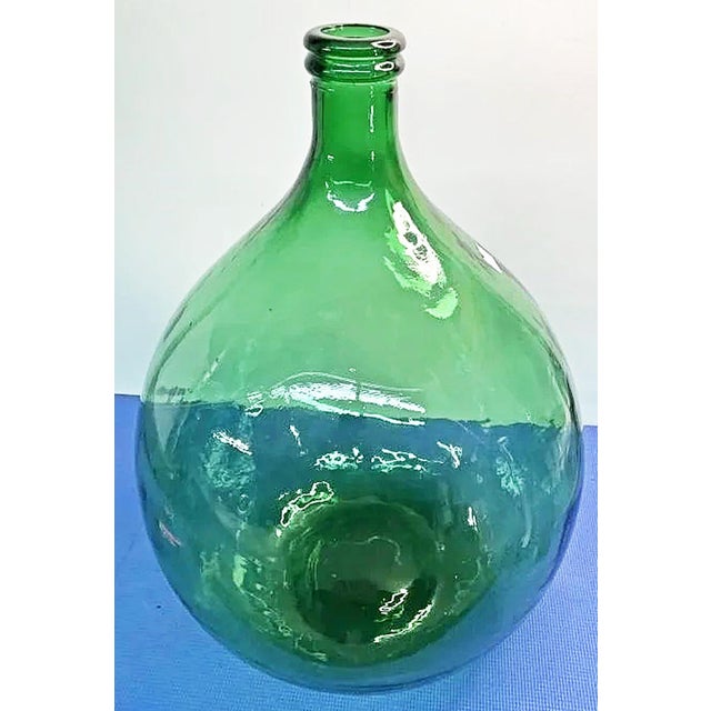 Who doesn't love the French oil and wine demijohn bottles? AKA carboys, this is hand mold blown with a plenty of included...
