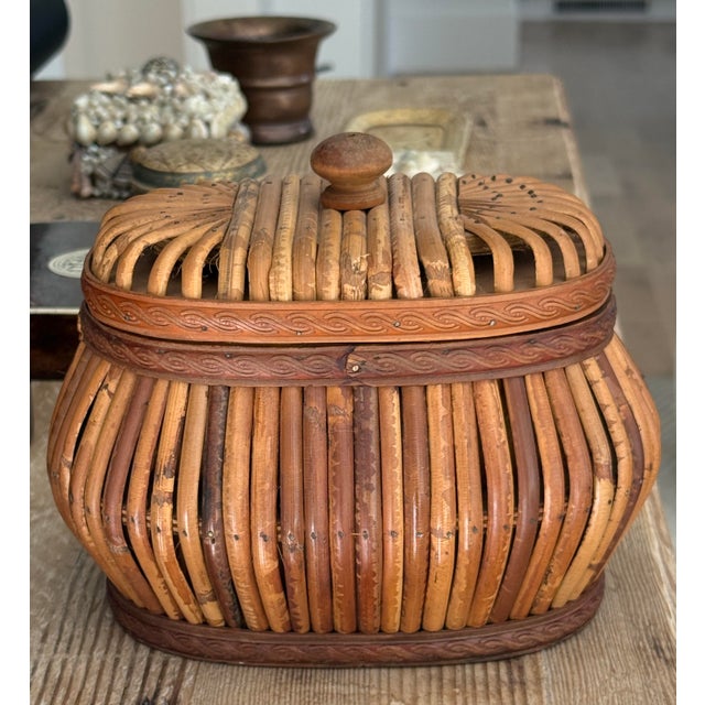 Mid century rattan box, oval shape. Carved filigreed band. Top knob.