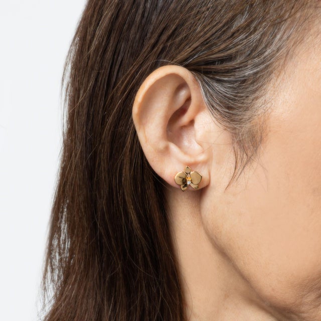 Estate Cartier 'Caresse D'Orchidees' earrings crafted in 18 karat yellow gold. 2 round brilliant cut diamonds total an...