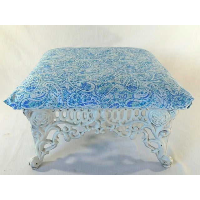 Wonderful mid-century roses cast iron blue and white upholstered footstool. Very ornate base. No stains or damage to the...