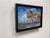 This oil on panel artwork presents a striking architectural study of the MAD Studios building, characterized by bold...