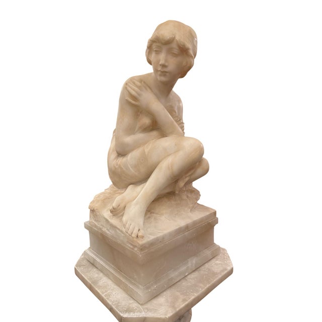 A magnificent early 20th century Italian carved alabaster floor lamp featuring a graceful sculpture of a young female...