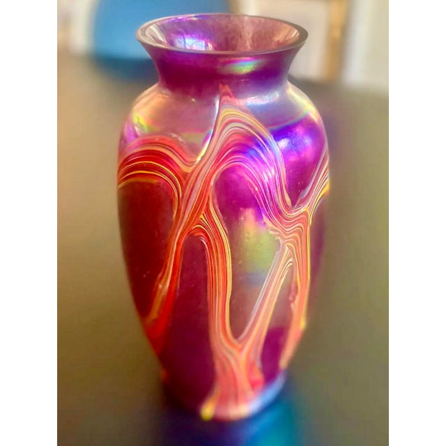 Studio art Favrile vase with a dappled base color, accented with lush swirled detail. Iridescent, luminous color. Circa...