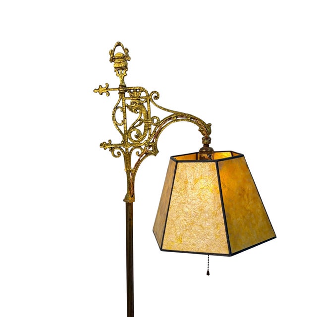 Beautiful floor lamp with decorative top in solid brass and a new golden mica shade that hangs off the socket.