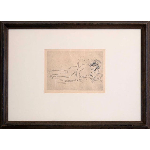 An Impressionist drypoint etching on cream wove paper titled “Femme Nue Couchee (Tournee a Droitte)” by Pierre-Auguste...