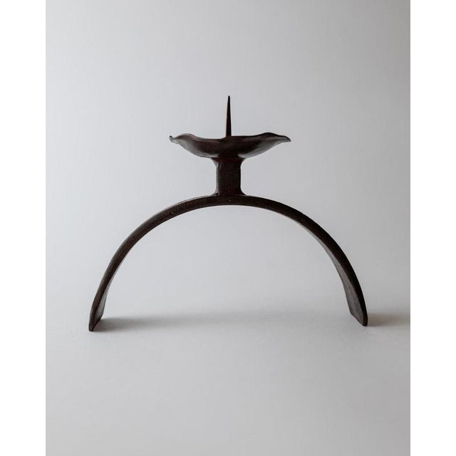 This vintage hand forged iron candle holder from the 1960s is a striking example of sculptural Mid Century metalwork....