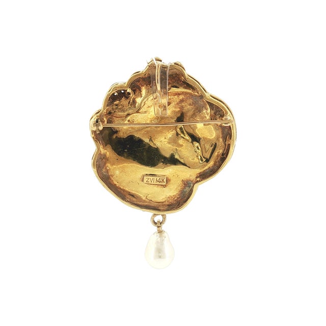 A stunning 1960's Art Nouveau revival pendant. Features a detailed profile of a woman. Crafted in 14k yellow gold. Adorned...