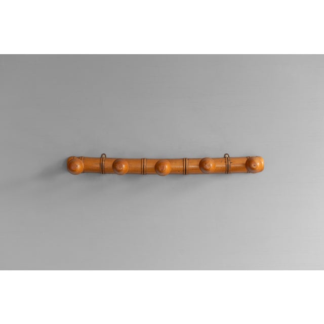 Faux bamboo coat rack with 5 posts in original polished finish. Circa 1930.