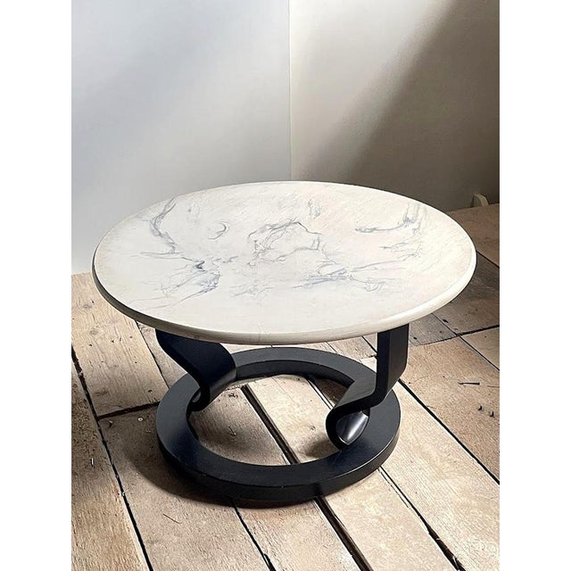 Distinctive Swedish postmodern coffee table dating from the 1980s, featuring a sculptural black base and a circular...
