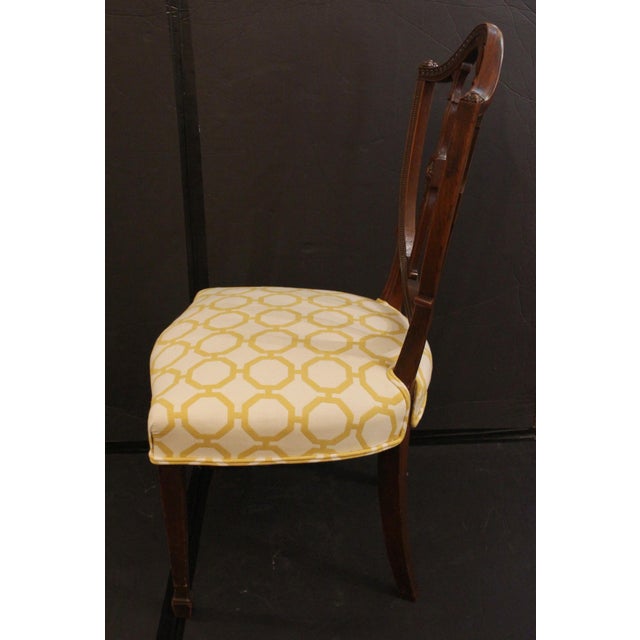 Late 18th century pair of George III period side chairs, English. Mahogany with bowed shield backs and serpentine seat...