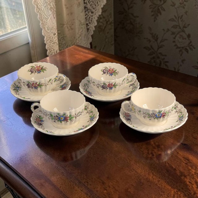 A set of four vintage Spode Copeland England tea cups and saucers with a beautiful floral pattern called Felicity. The...