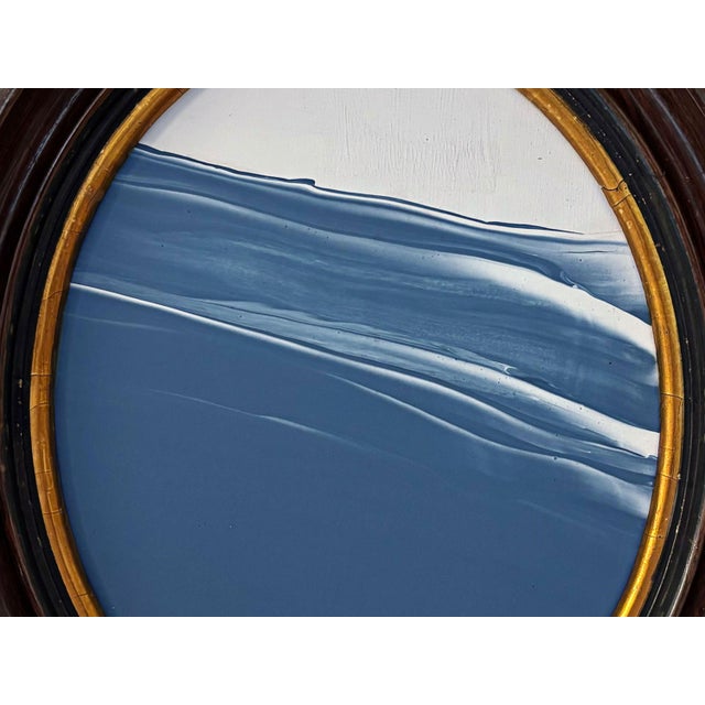 Step into a moment of stillness with "Porthole XX” Housed in an intricately detailed antique frame, this piece evokes a...
