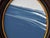Step into a moment of stillness with "Porthole XX” Housed in an intricately detailed antique frame, this piece evokes a...