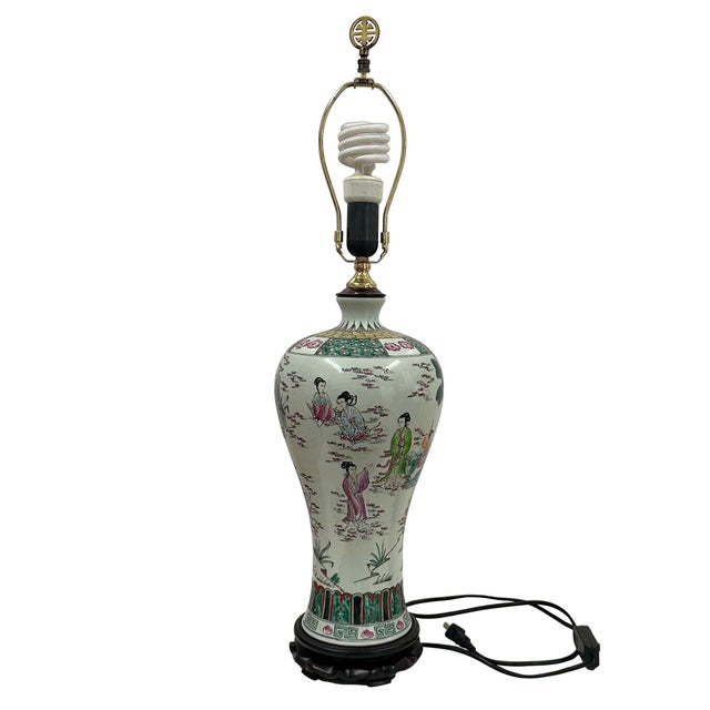 A vintage famille rose porcelain table lamp from the mid-20th century with fairies and landscaping design. Born in China...