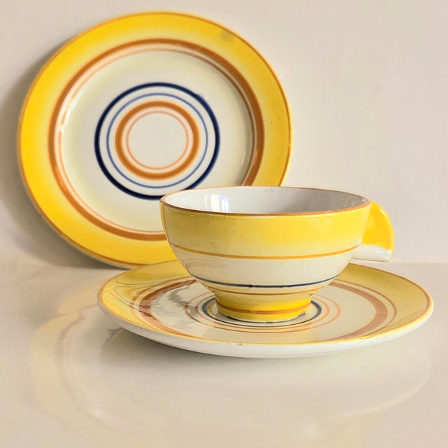The glaze is partly sprayed, but mostly hand-painted. Cheerful, clear, radiant colors. Geometric decoration and geometric...