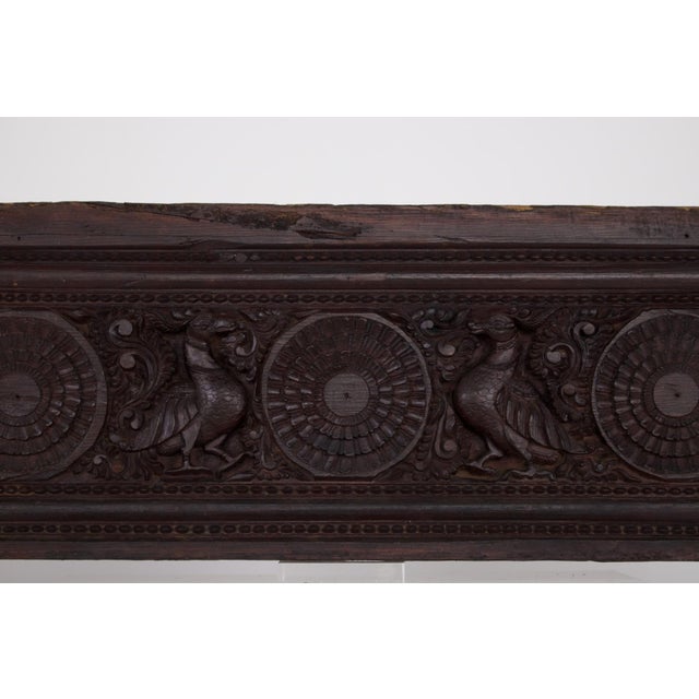 Carved from satinwood (Chloroxylon swietenia) from the East Indies, this antique Indian panel combines lotus flower motifs...