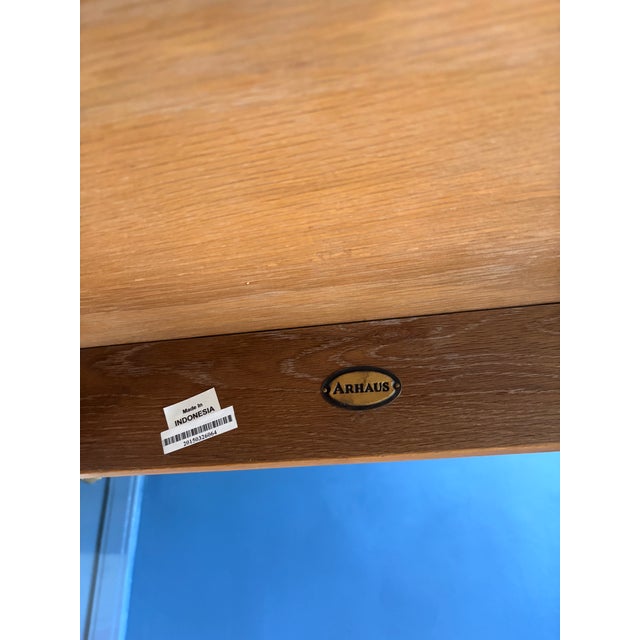 Arhaus table with self storing extensions. 54 inches with two 18 inch extensions. Extends to 90 inches 36 inches wide