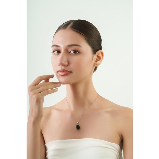 The Minimalist Prong-Set Oval 7.29 Ct Black Onyx Solitaire Pendant features a striking 7.29-carat Black Onyx gemstone in a...