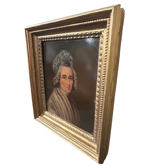 Painting of a smiling woman wearing a daycap with a blue bow. Label reads Charles Roberson & Compy. Stamped "Cranfield...