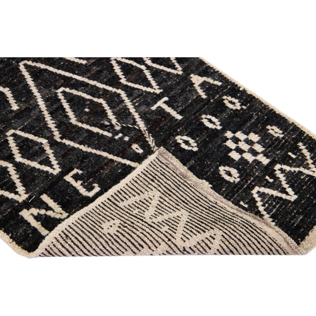 Beautiful Moroccan-style handmade wool rug with a brown field. This Modern rug has beige accents featuring a gorgeous all-...