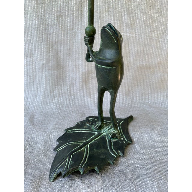 Whimsical vintage bronze frog standing on a leaf candlestick. No marks. Candlestick measures 7" by 4" by 12". Lovely...