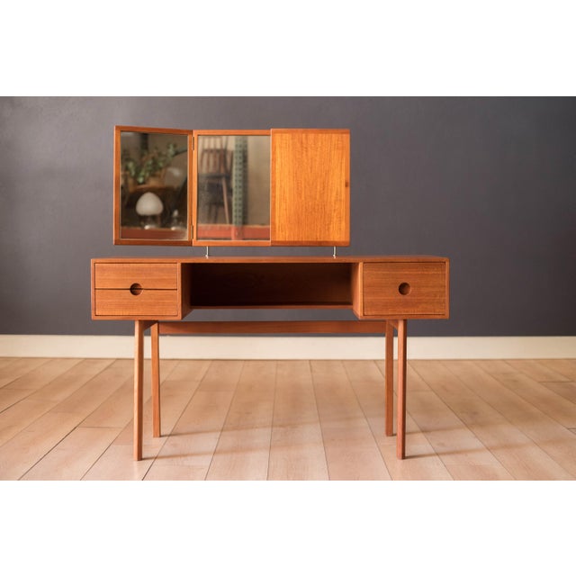 Mid Century Modern vanity dressing table in teak designed by Kai Kristiansen for Aksel Kjersgaard, Denmark. Features sleek...