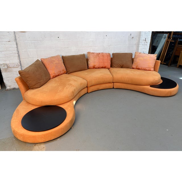 A bold and stylish Italian multisectional sofa upholstered in vibrant orange suede, manufactured by Roche Bobois....