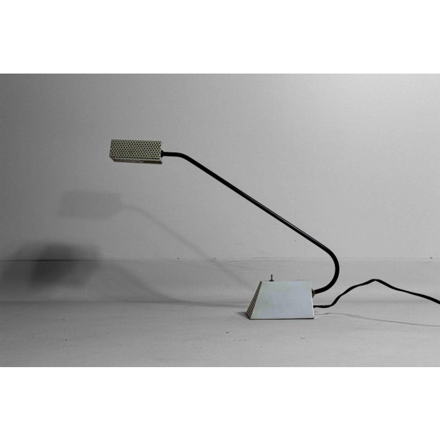 This formal French desk lamp from the 1950s features a white metal base and shade with geometrical holes pierced in them....