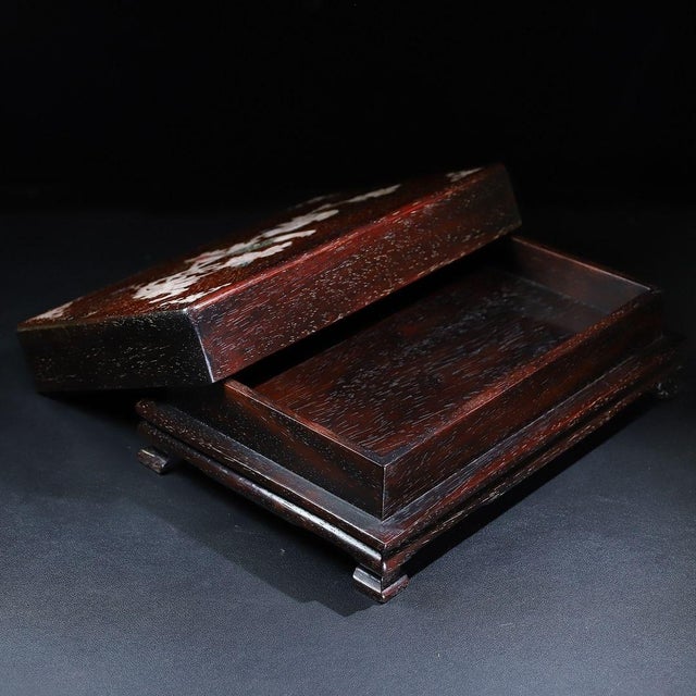 This is a beautifully crafted rectangular wooden box featuring intricate mother-of-pearl (nacre) inlay work on the lid....