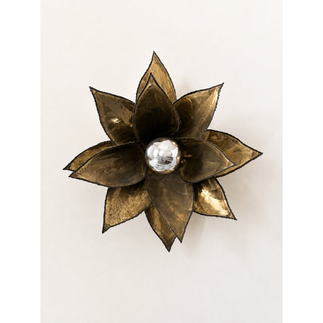 Pair of patinated brass wall sconces with a floral motif, produced in France in the 1960s. Original and elegant design....
