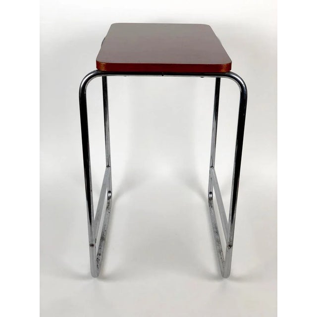 Made in the 1930s, this table is composed of a steel tube base that has been chrome-plated, the top is made of wood with a...