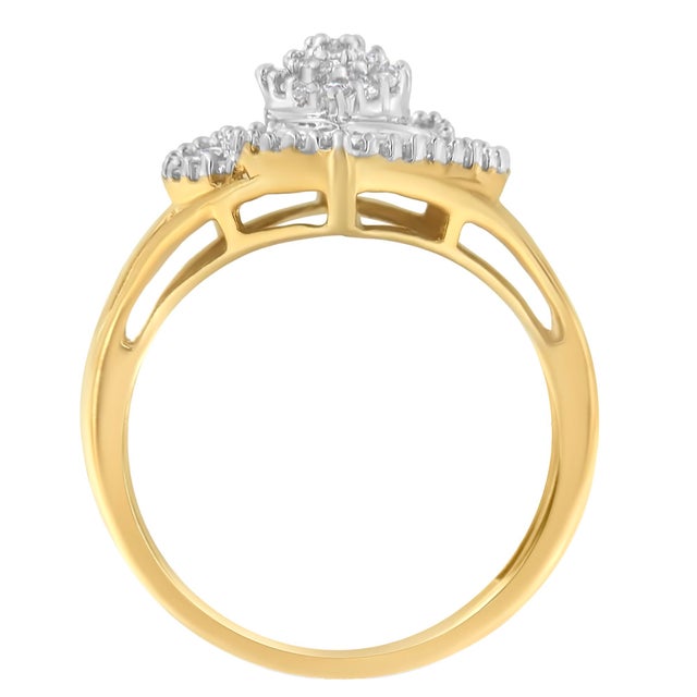 A diamond cocktail ring that sparkles with a central marquise-shaped cluster of round brilliant cut diamonds surrounded by...