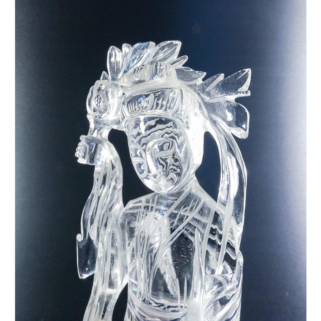 Rock crystal sculpture depicting a female figure (perhaps guanyin) with a bouquet of flowers. China, 20th century. Origin...