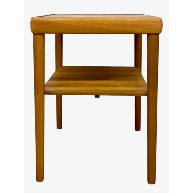 This vintage mid century modern end table features a clean, functional design with subtle sculptural details. The...