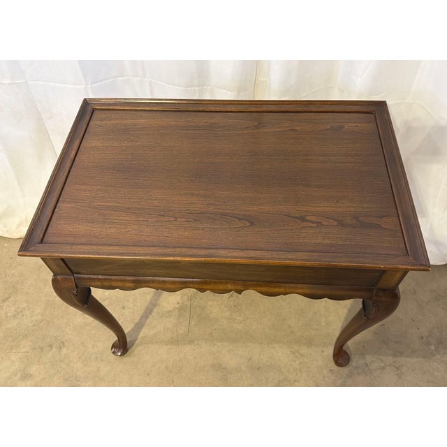 Bring timeless elegance to your space with this classic Queen Anne style tea table from the highly collectible Ethan Allen...