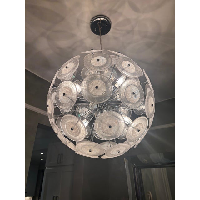 Murano glass disc light fixture. 6 lights on the inside 60W each. Approximately 17" of cord from the canopy and the...