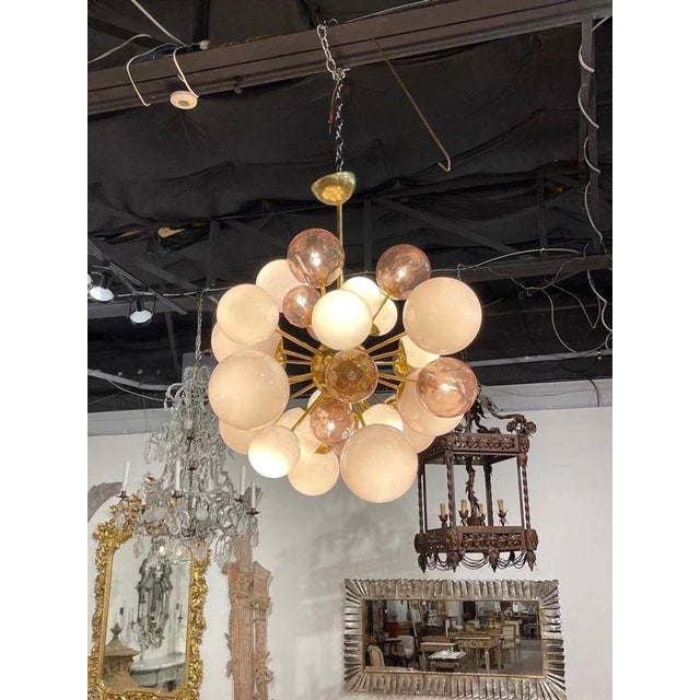 Stunning modern Murano glass and brass pink cloud chandelier. An amazing fixture with different sizes and shades of pink...